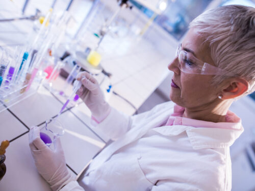 Mature female chemist working on scientific experiment in the lab